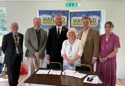 Members of Wayland Partnership and representatives of Zhovkva stand together with the signed papers